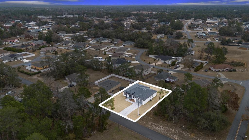 An aerial view shows a single-story house with a white exterior and gray roof — 15303 SW 48TH AVENUE, OCALA, FL