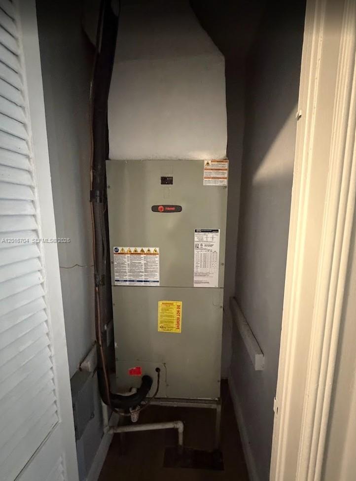 A Trane HVAC air handler unit is installed inside a small utility closet — MIAMI, FL