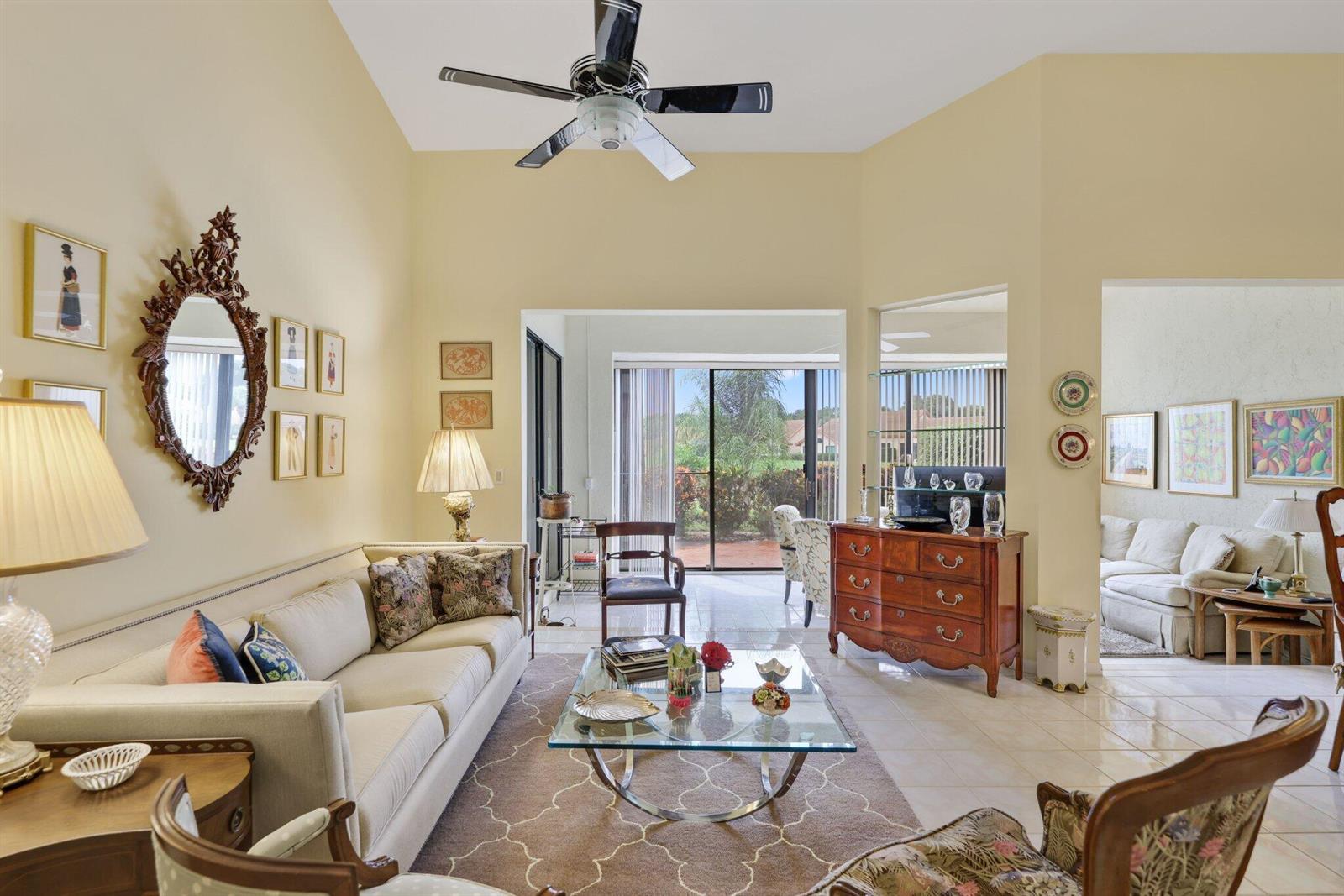 A living room with a ceiling fan, beige walls, a glass coffee table, and tile flooring — 8423 Juddith Avenue, Boynton Beach FL 33472, BOYNTON BEACH, FL