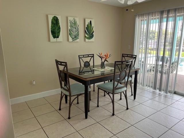 A dining area features a glass-topped table, four chairs, and three botanical wall art pieces — 4192 GINGOLD STREET, PORT CHARLOTTE, FL