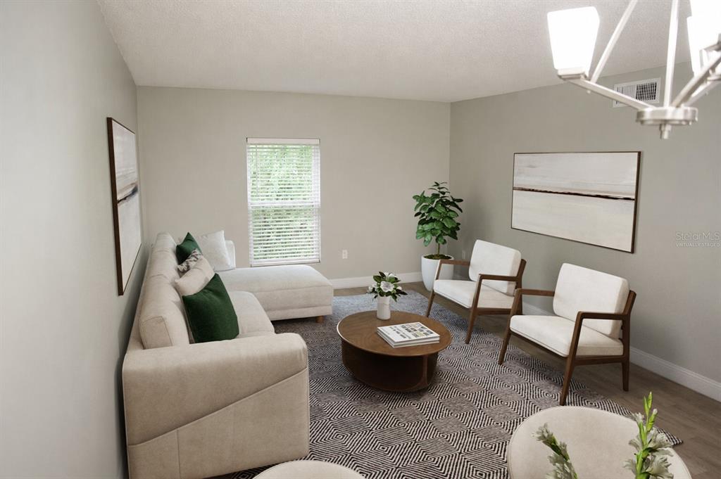 A living room features a sectional sofa, two armchairs, a coffee table, and a patterned rug — 165 PICARDY VILLA CIRCLE UNIT 201, BRANDON, FL
