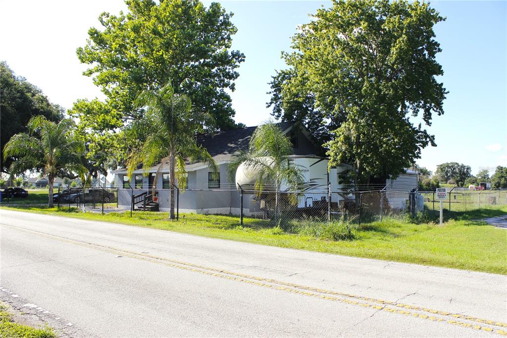 A single-story house with a camper parked in the yard behind a chain-link fence — 2207 SPARKMAN ROAD, PLANT CITY, FL