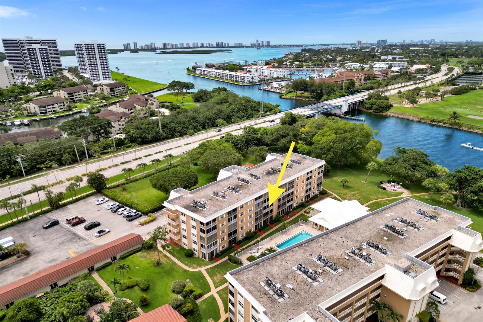 An aerial view shows a multi-story apartment building with a pool and surrounding landscape — 304 Golfview Road # 304, North Palm Beach FL 33408, NORTH PALM BEACH, FL