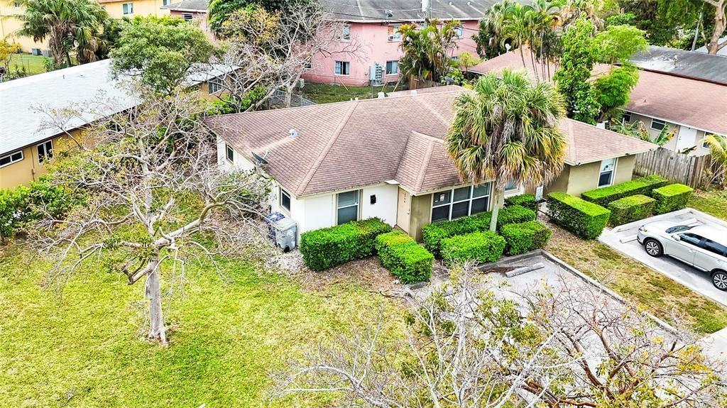 An aerial view shows a single-story house with a brown roof and a palm tree — 330 SW Avondale Drive, Pompano Beach FL 33060, POMPANO BEACH, FL