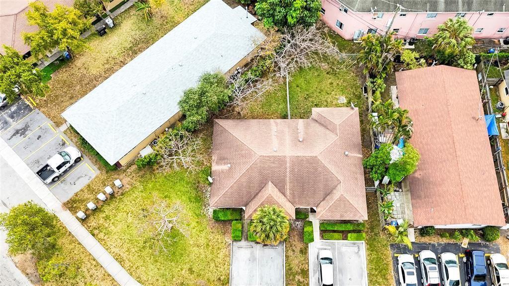 An aerial view shows a residential building with a brown roof surrounded by parking areas — 330 SW Avondale Drive, Pompano Beach FL 33060, POMPANO BEACH, FL