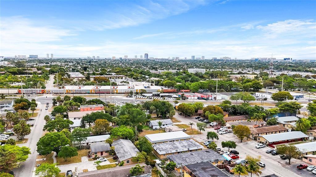 An aerial view shows a residential neighborhood with a train passing through the background — 330 SW Avondale Drive, Pompano Beach FL 33060, POMPANO BEACH, FL