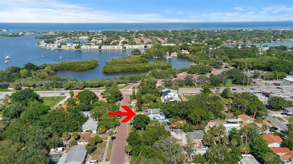 An aerial view shows a residential neighborhood with a red arrow pointing toward a house — 626 37TH AVENUE S, ST PETERSBURG, FL