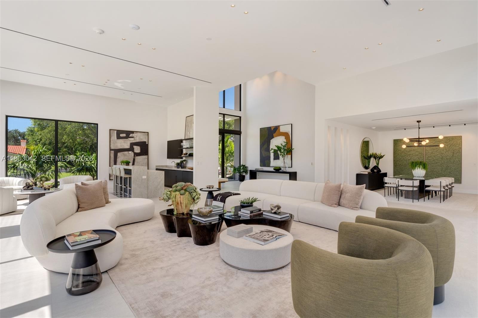 A modern two-story house with large glass windows overlooks a rectangular swimming pool at dusk — 5825 SW 111th Ter, Pinecrest FL 33156, PINECREST, FL