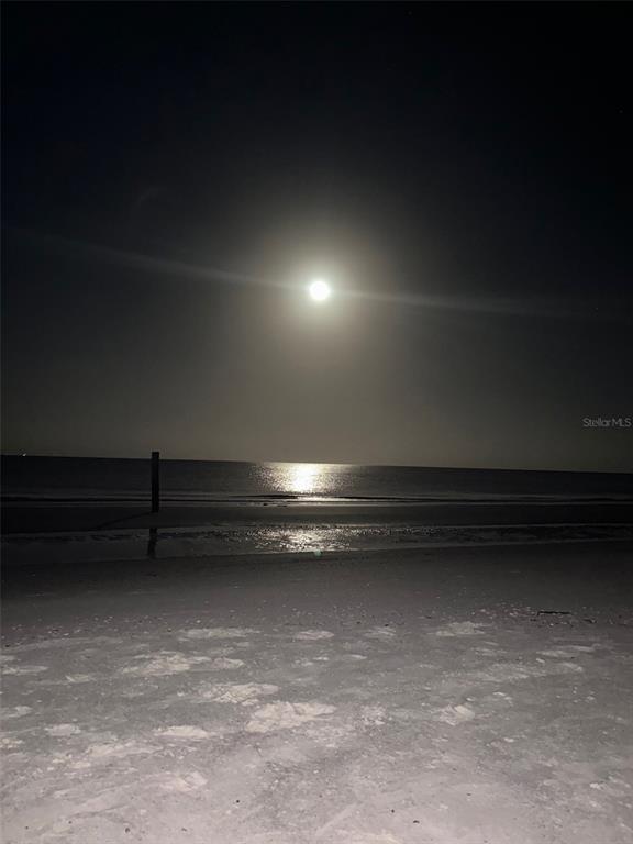 A full moon shines over a dark beach at night with a single wooden post — 18218 SUNSET BOULEVARD UNIT B, ST PETERSBURG, FL