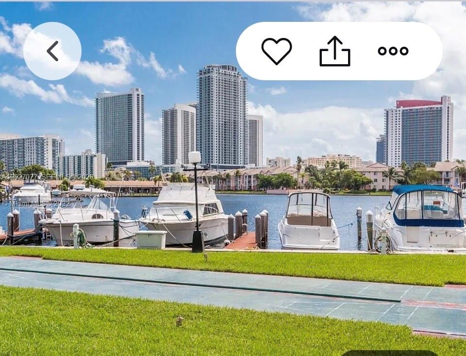 A view of boats docked at a marina with high-rise buildings in the background — 600 Three Islands Blvd # 312, Hallandale Beach FL 33009, HALLANDALE BEACH, FL