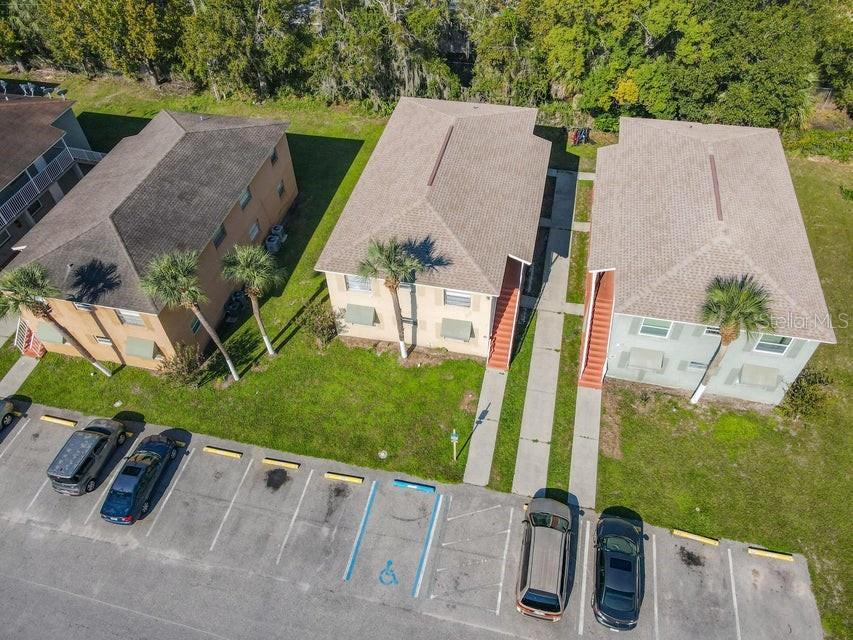 An aerial view shows three multi-story apartment buildings with parking spaces in the foreground — 714 MICHIGAN COURT UNIT 1, 2, 3 and 4, ST CLOUD, FL