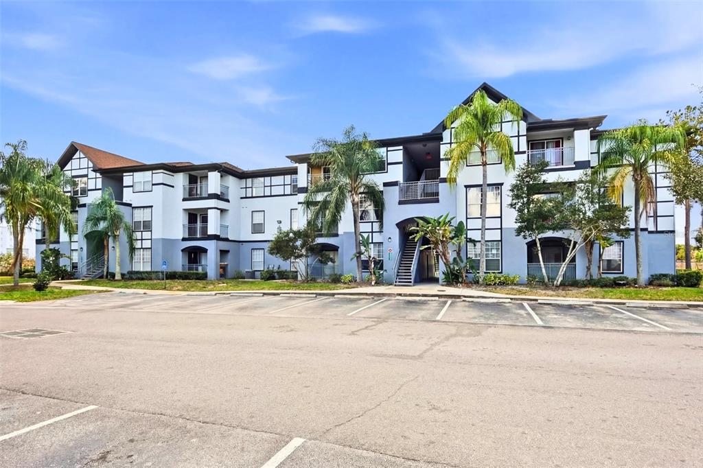 An empty room with gray walls, tile flooring, a ceiling fan, and a sliding glass door — 5526 PGA BOULEVARD UNIT 4927, ORLANDO, FL
