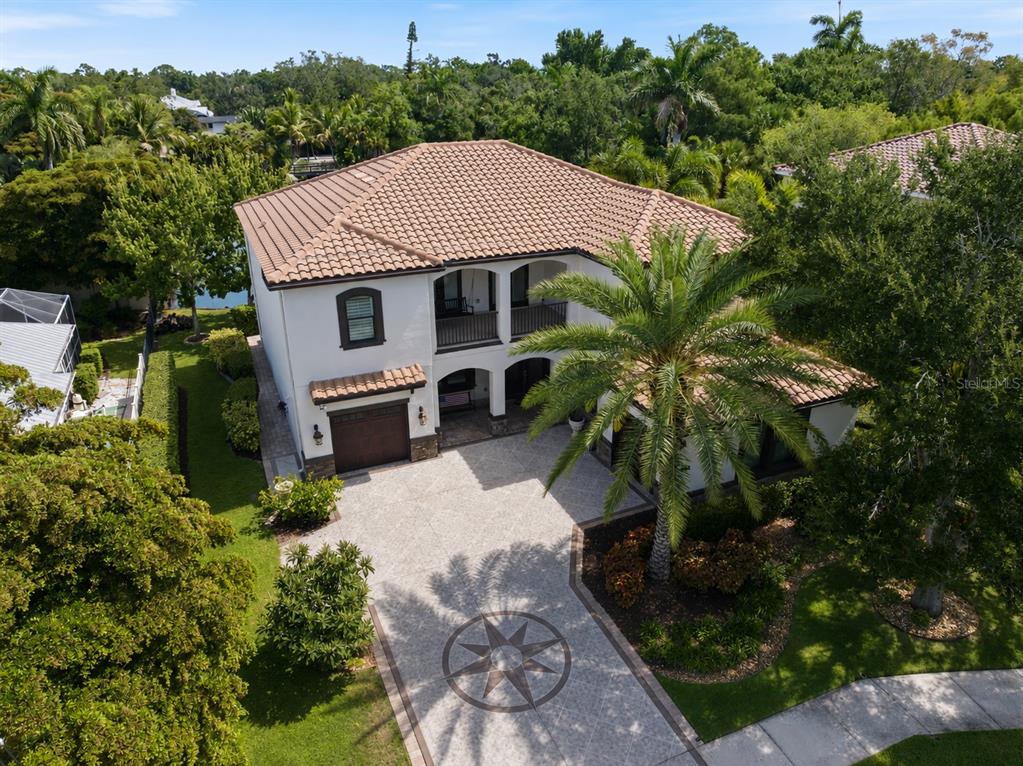 An aerial view shows a two-story white house with a tile roof and paved driveway — 1711 KENILWORTH STREET, SARASOTA, FL