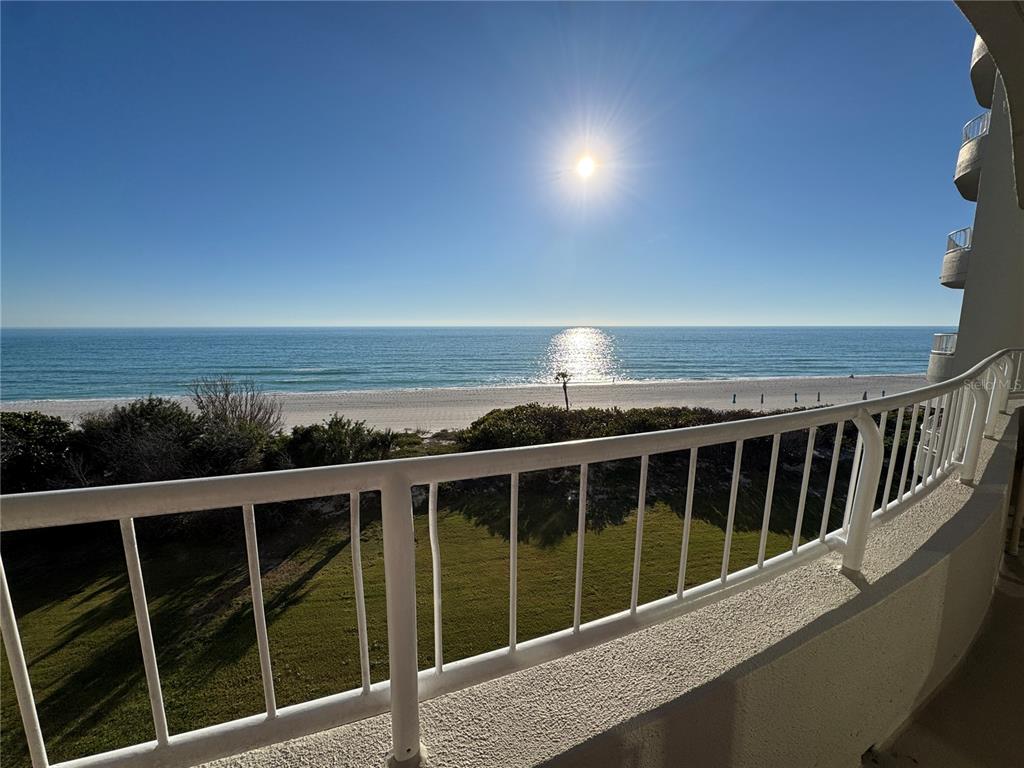 A balcony with a white railing overlooks a sandy beach and the ocean — 775 LONGBOAT CLUB ROAD UNIT 401, LONGBOAT KEY, FL