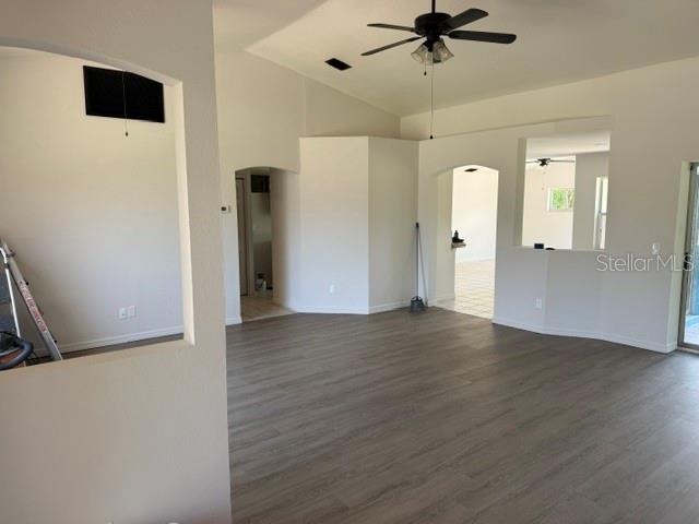 An open-concept living area features light-colored walls, wood-look flooring, and a ceiling fan — 2576 TRIANNA STREET, NORTH PORT, FL