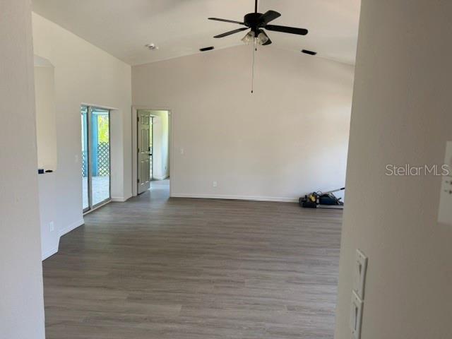 An interior view of a room with light-colored walls, wood-look flooring, and a ceiling fan — 2576 TRIANNA STREET, NORTH PORT, FL
