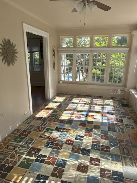 A sunroom features a multi-colored tiled floor, large windows, and a ceiling fan — 1225 11TH STREET N, ST PETERSBURG, FL