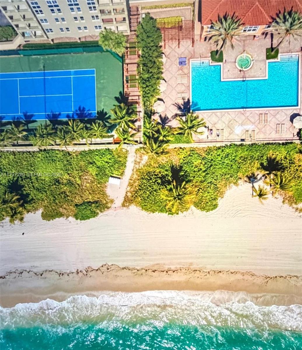 An aerial view shows a beach, a swimming pool, and a tennis court — 2080 S Ocean Dr # 502, Hallandale Beach FL 33009, HALLANDALE BEACH, FL