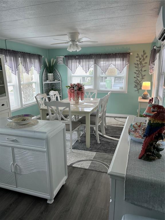 A dining area features a white table, chairs, light green walls, and a ceiling fan — 1413 24TH AVENUE W, BRADENTON, FL