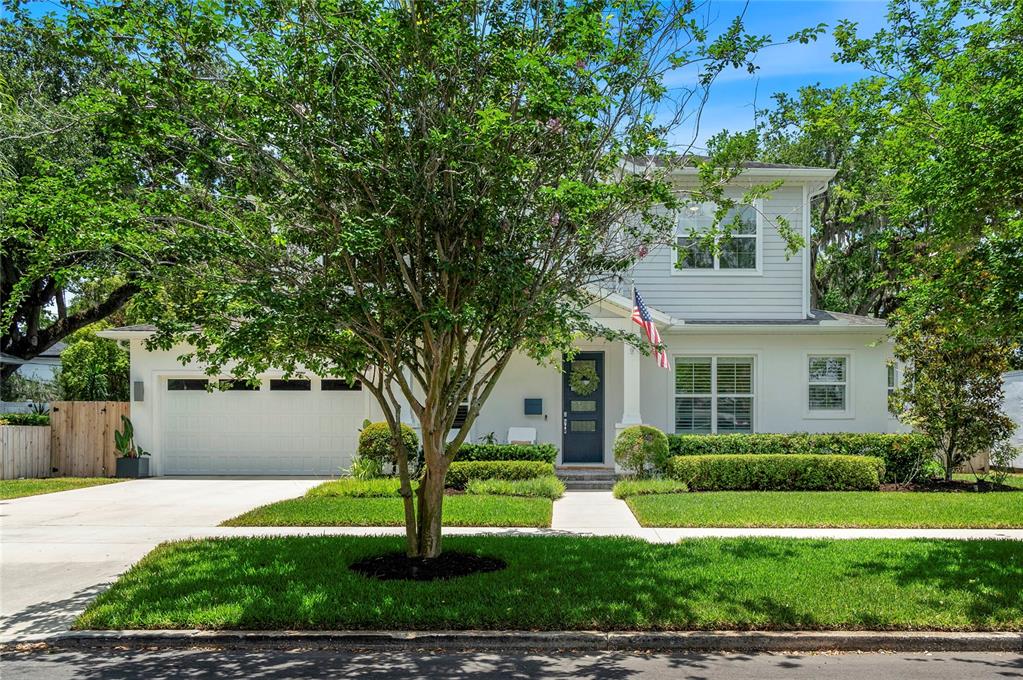 A two-story house with a white exterior, a two-car garage, and a front yard — 1438 W HARVARD STREET, ORLANDO, FL