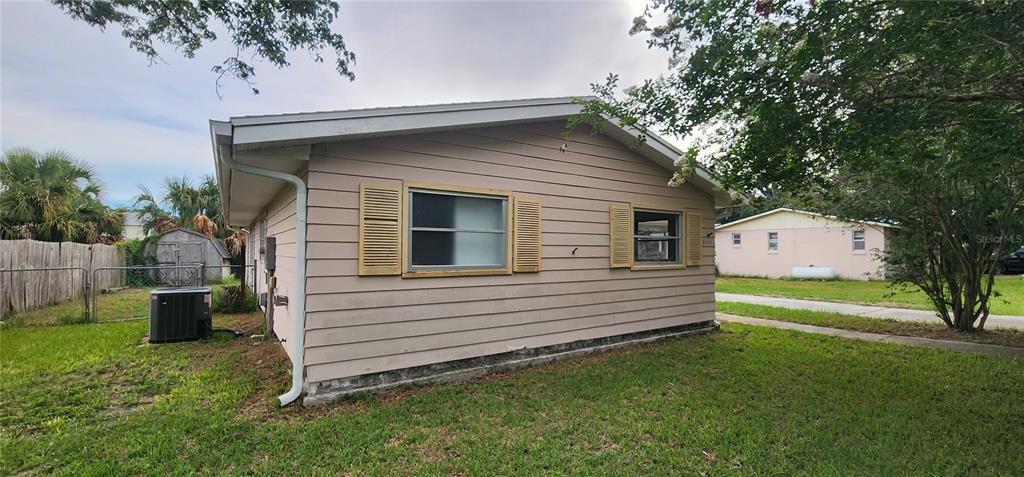 The exterior of a beige, single-story house with horizontal siding and yellow shutters — 3576 SW 147TH LANE ROAD, OCALA, FL