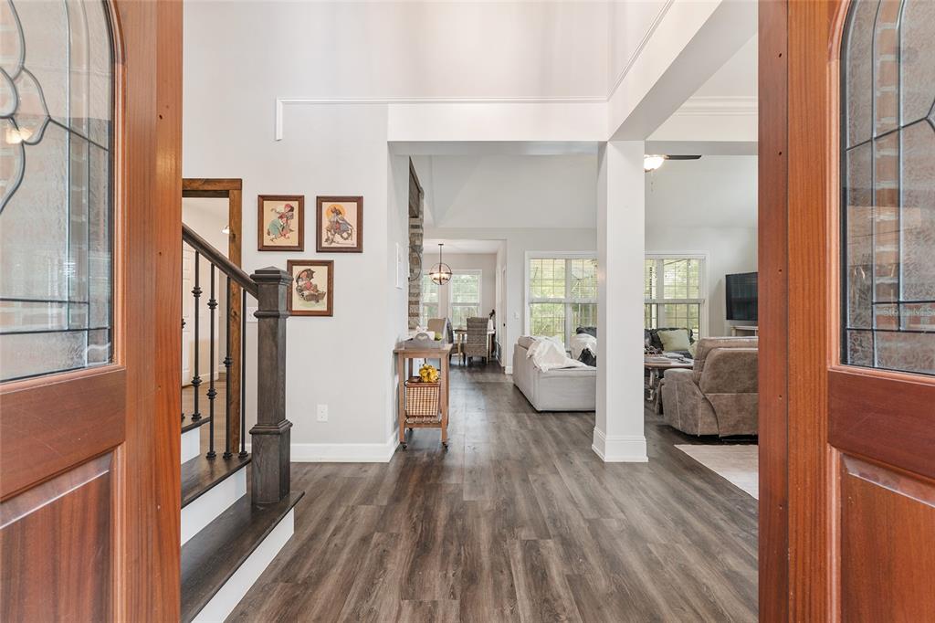 A view from a doorway into a home with wood-look flooring and a staircase — 5512 NW 51ST AVENUE, GAINESVILLE, FL