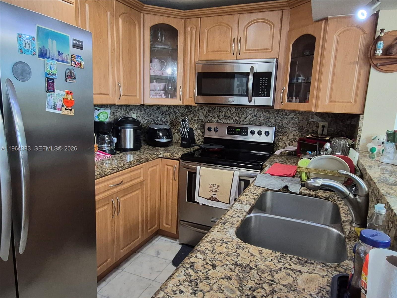 A kitchen features light wood cabinets, granite countertops, stainless steel appliances, and a double sink — 11800 SW 18th St # 4, Miami FL 33175, MIAMI, FL
