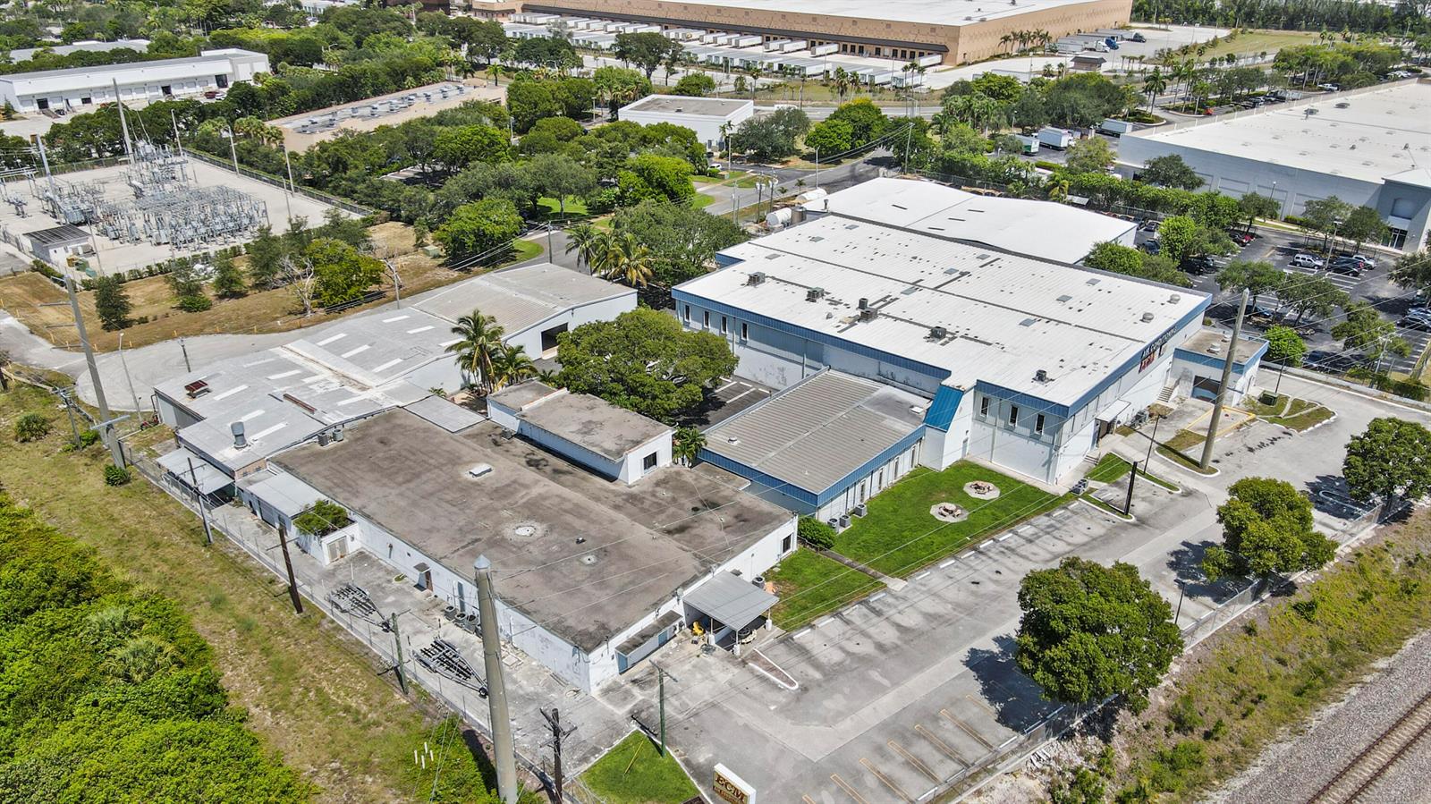 An aerial view shows a commercial building complex with parking lots and surrounding greenery — 1500 High Ridge Road, Boynton Beach FL 33426, BOYNTON BEACH, FL