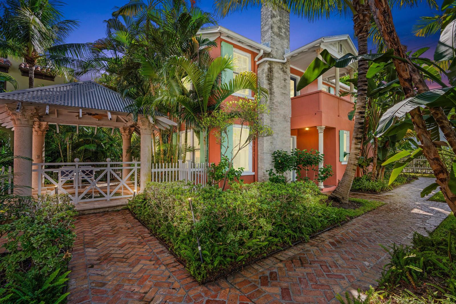 A two-story coral-colored house with a brick walkway, a gazebo, and lush tropical landscaping — 102 SE 7th Avenue # 2, Delray Beach FL 33483, DELRAY BEACH, FL