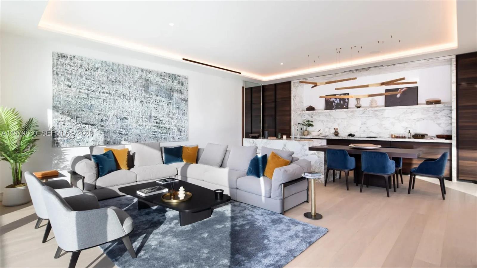 A modern living room features a large grey sectional, blue area rug, and marble kitchen island — 346 Marasi drive # 0, FL Dubai, FL