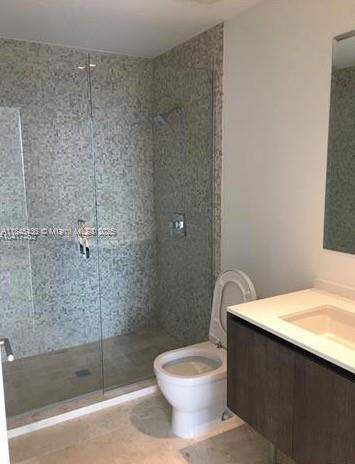 A bathroom featuring a glass-enclosed walk-in shower with mosaic tile walls and a modern vanity — 88 SW 7th St # 2603, Miami FL 33130, MIAMI, FL
