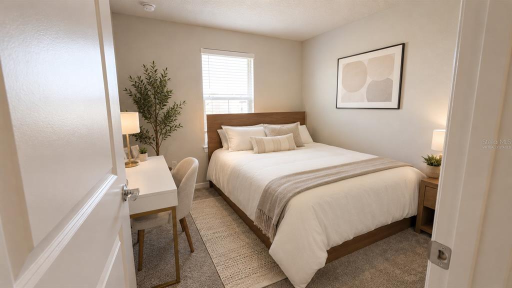 A bedroom features a queen bed, a desk with a chair, and a window — 1965 BRANCHED OAK ROAD, ST CLOUD, FL
