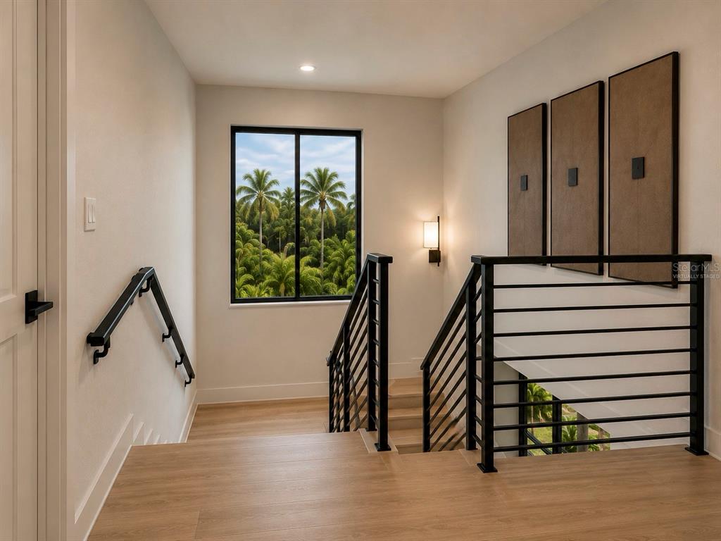 A staircase landing features light wood flooring, a black metal railing, and a window view — 3904 DANA SHORES DRIVE, TAMPA, FL