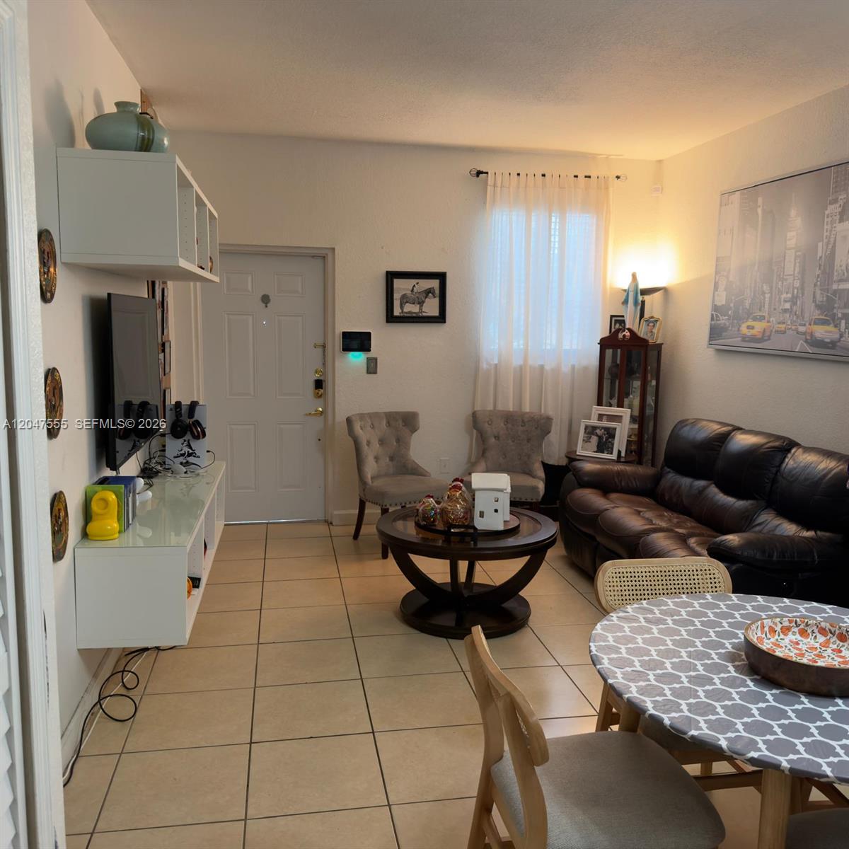 A living room features tile flooring, a dark leather sofa, and a dining area — 17820 NW 73rd Ave # 1, Hialeah FL 33015, HIALEAH, FL