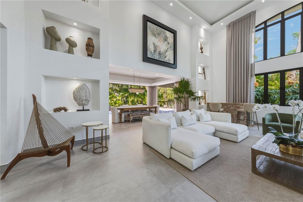 A bright, high-ceilinged living room features white walls, a large sectional sofa, and wall niches — 29 DORADO BEACH EAST, DORADO, PR
