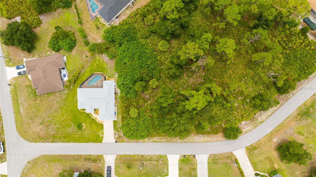 An aerial view shows a residential lot with a house, pool, and surrounding wooded area — HIGHTOWER ROAD, NORTH PORT, FL