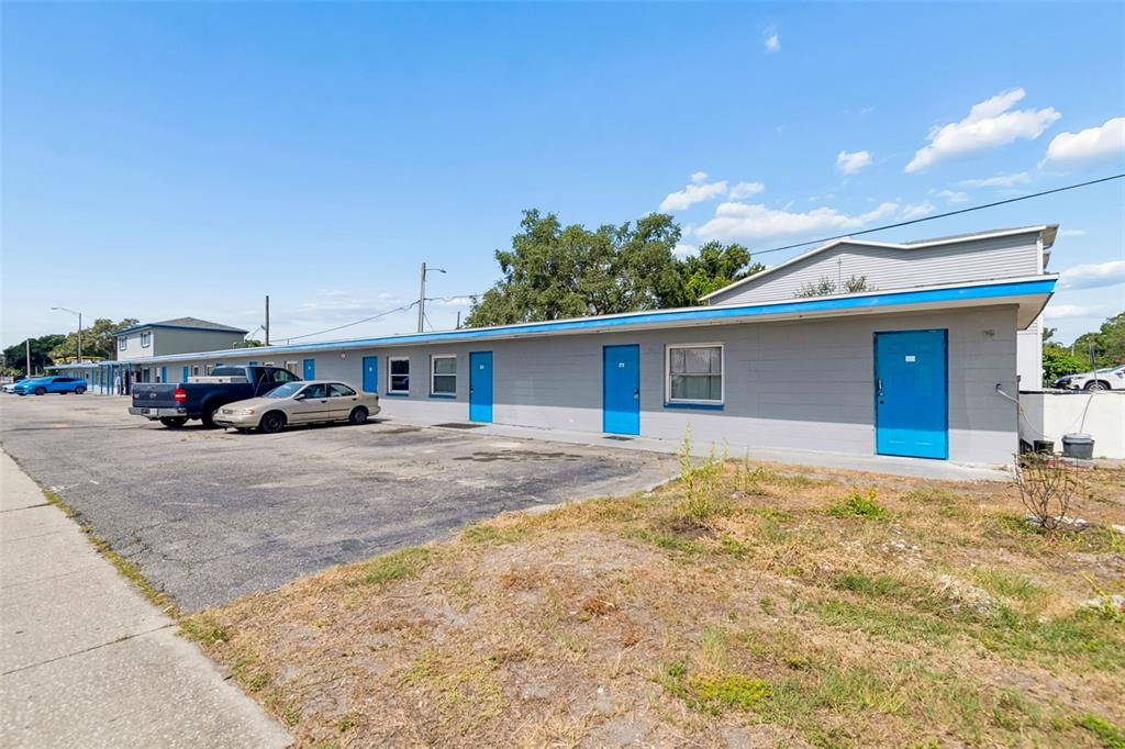 A single-story motel building with gray exterior walls and bright blue doors — 6409 S DALE MABRY HIGHWAY, TAMPA, FL