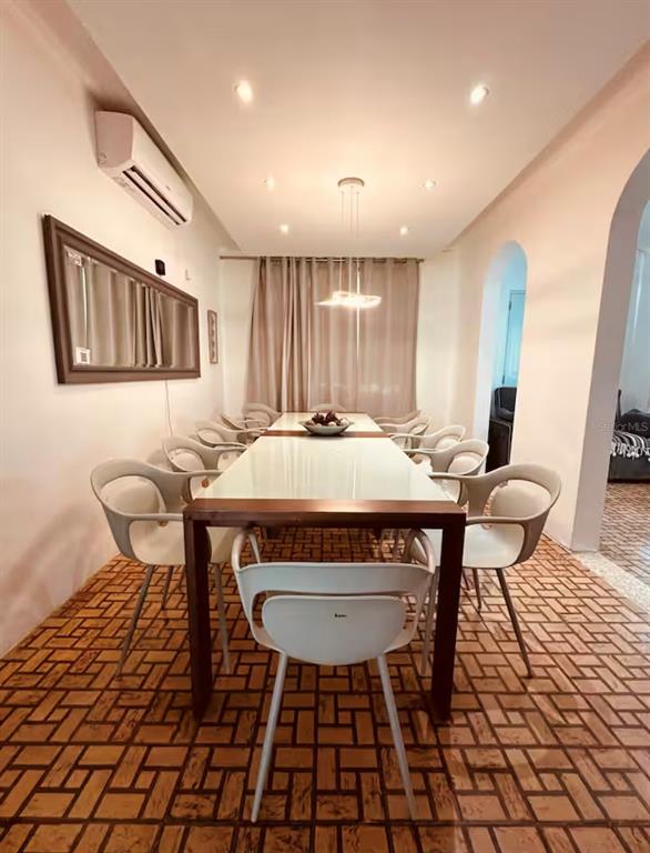 A dining room features a long white table, modern chairs, and a patterned tile floor — 13 CALLE VILLA INTERNACIONAL 2, SAN JUAN, PR