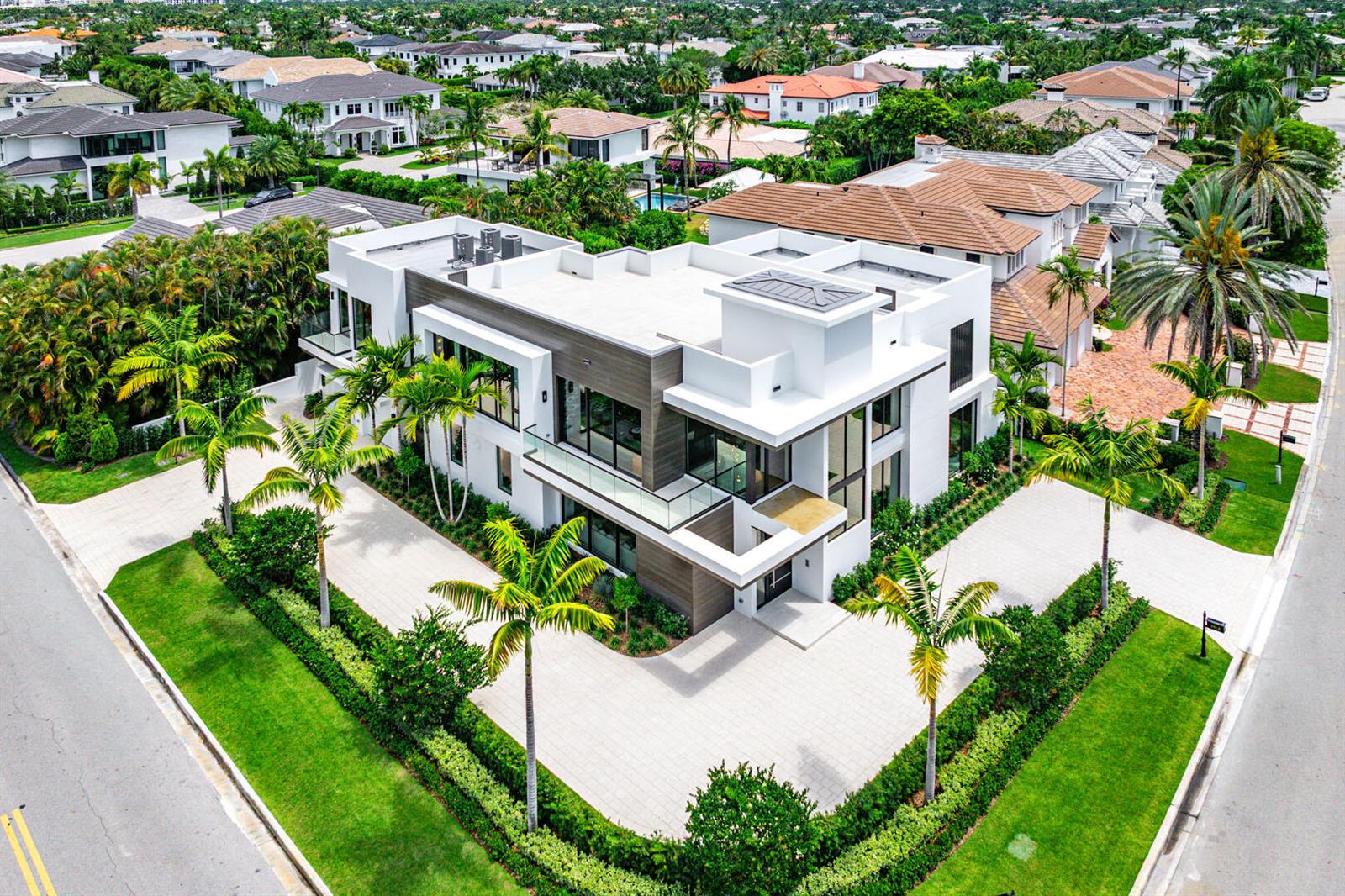 An aerial view of a modern two-story white house with a flat roof and palm trees — 303 S Maya Palm Drive, Boca Raton FL 33432, BOCA RATON, FL