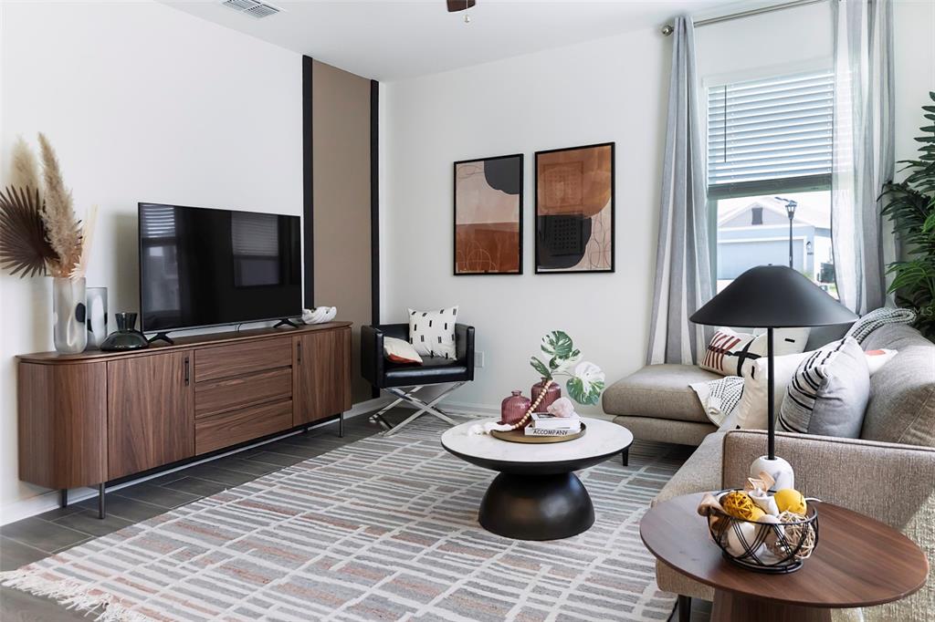 A modern living room features a wood media console, a sectional sofa, and a rug — 6056 PEACEFUL PARK WAY, CLERMONT, FL