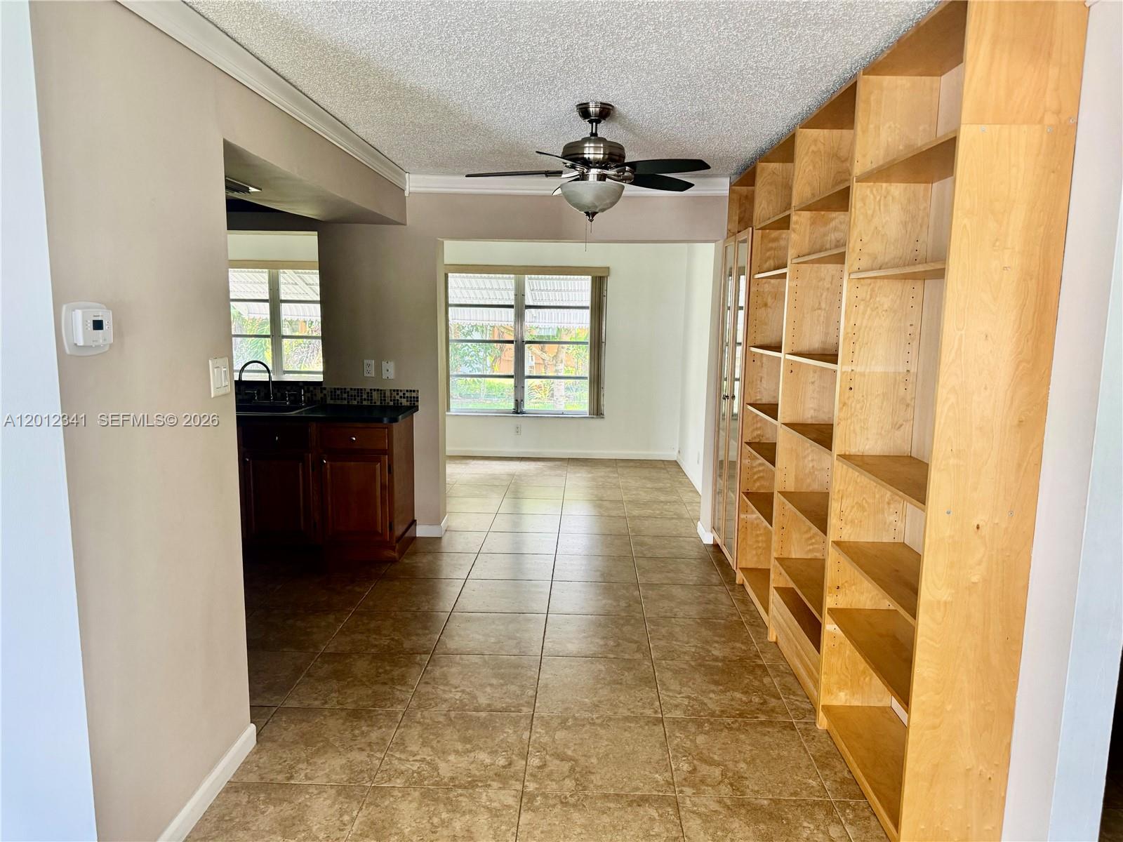 A room with tile flooring and two windows looking out onto a grassy yard — 1010 NW 72nd Ter # 0, Margate FL 33063, MARGATE, FL