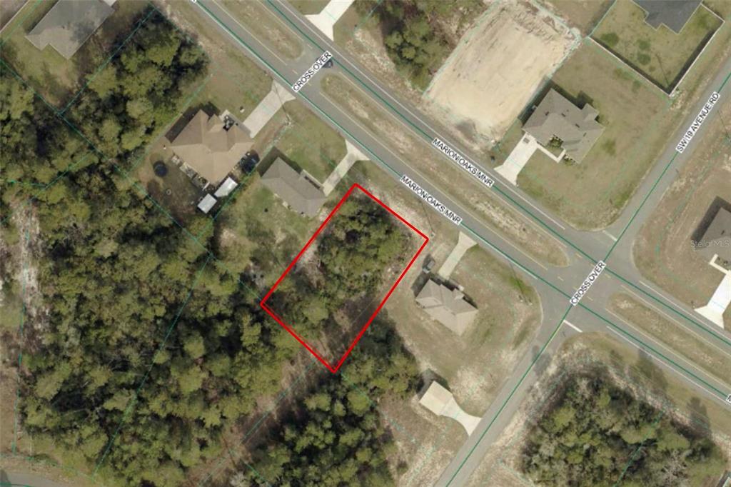 An aerial view shows a vacant, rectangular lot outlined in red along a residential street — TBD MARION OAKS MNR, OCALA, FL