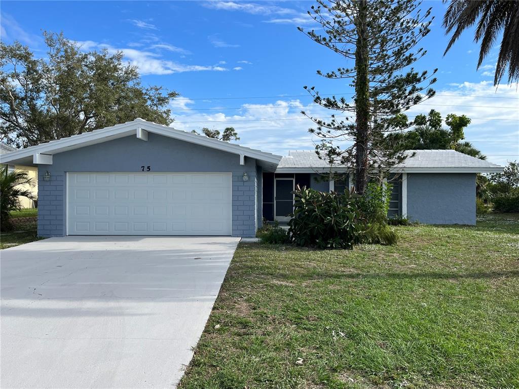 A single-story house with a blue exterior, white roof, and a two-car garage — 75 ANNAPOLIS LANE, ROTONDA WEST, FL