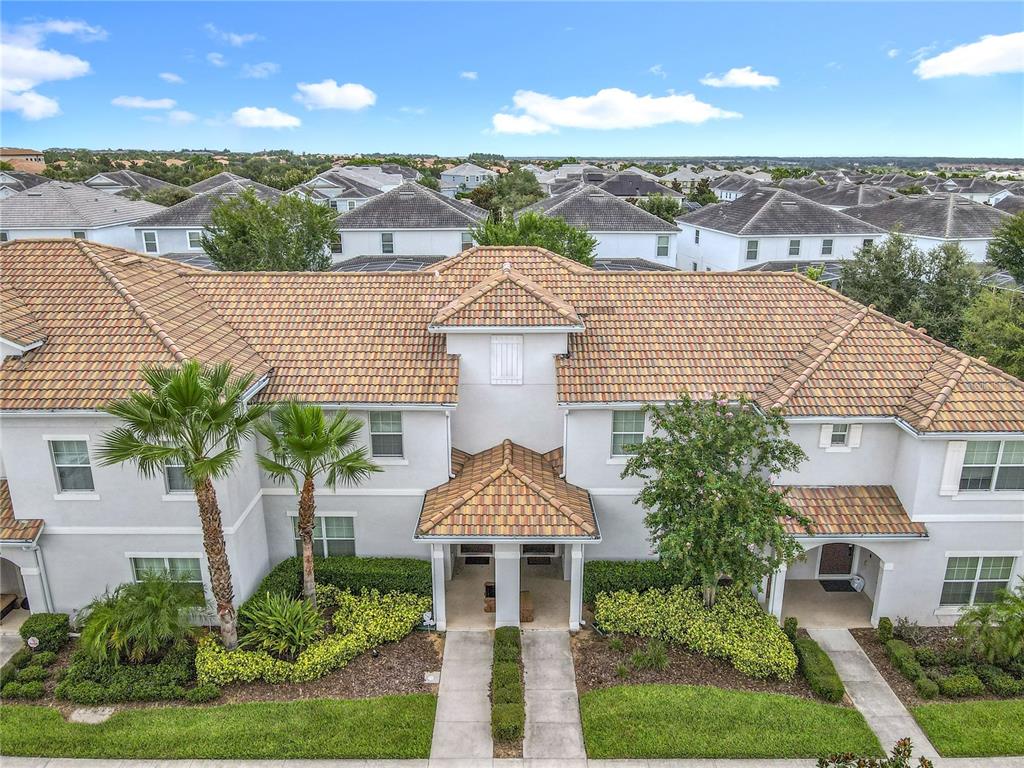 An open-concept living area features a kitchen island, dining table, and a television on a stand — 9053 DOGLEG DRIVE, DAVENPORT, FL