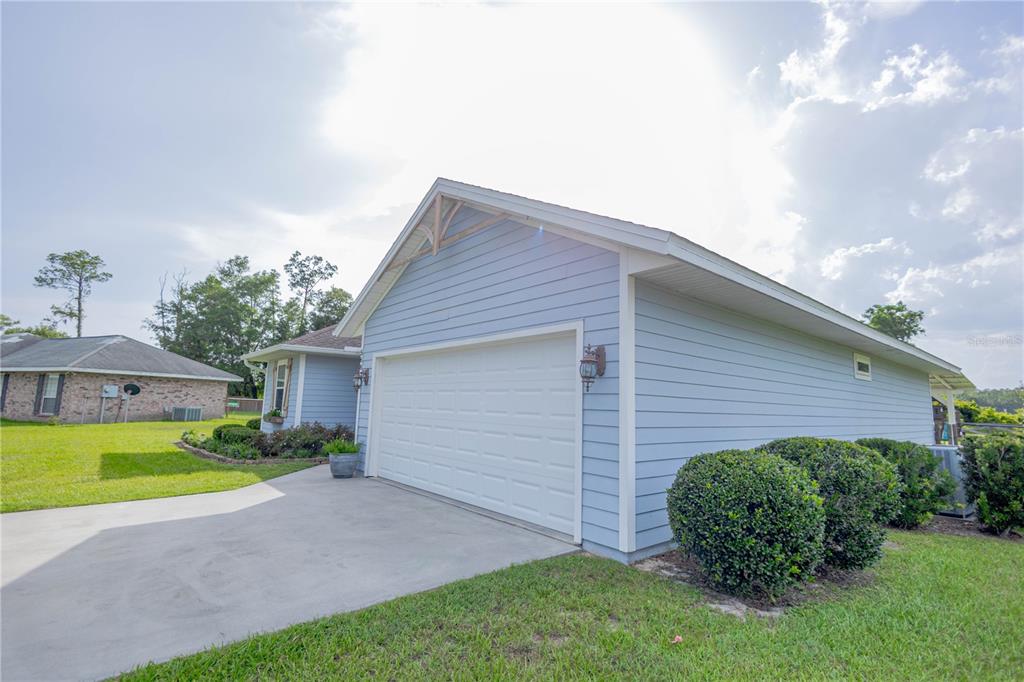 A light blue house with a two-car garage and a concrete driveway — 568 SW GERALD CONNER DRIVE, LAKE CITY, FL