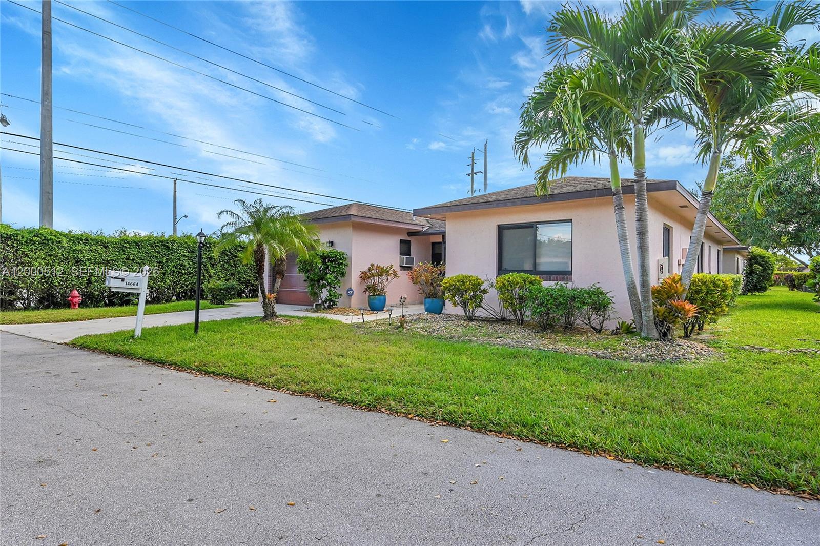 A single-story pink house with a palm tree and a manicured lawn — 14664 Bonaire Boulevard # 1, Delray Beach FL 33446, DELRAY BEACH, FL
