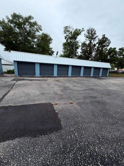 A row of storage units with blue walls and a white metal roof — 651 W DESOTO STREET, CLERMONT, FL