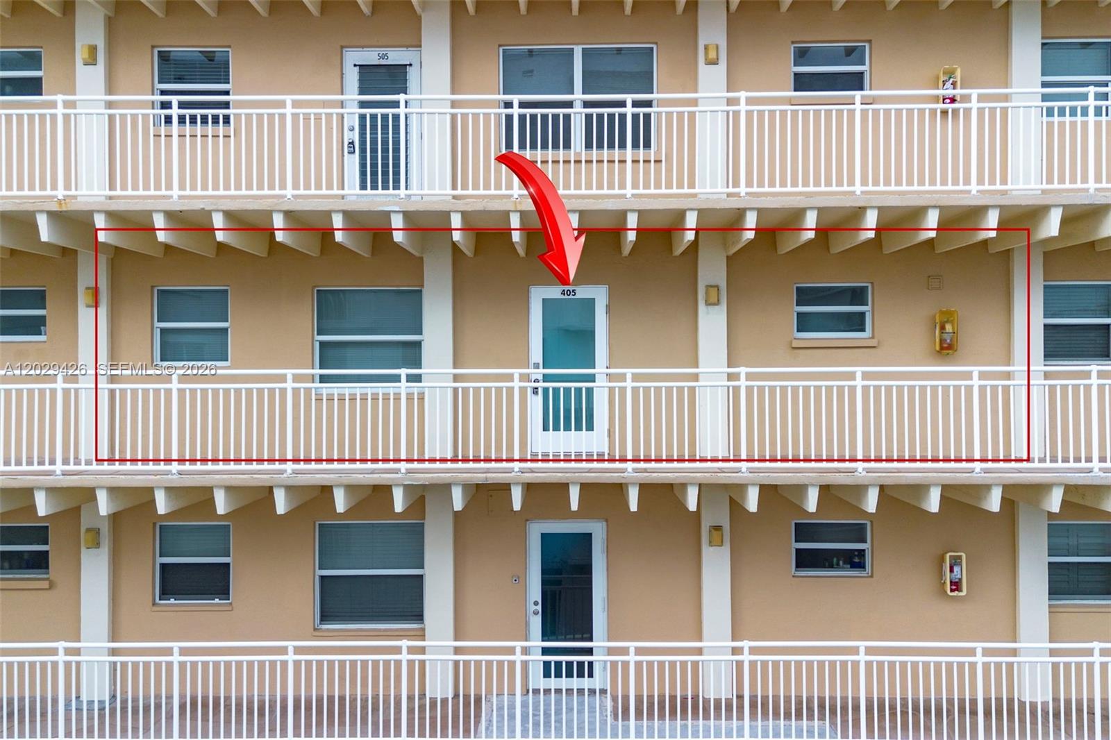 An exterior view of a multi-story apartment building featuring balconies and unit doors — 4500 S Ocean Blvd # 405, Lantana FL 33480, LANTANA, FL