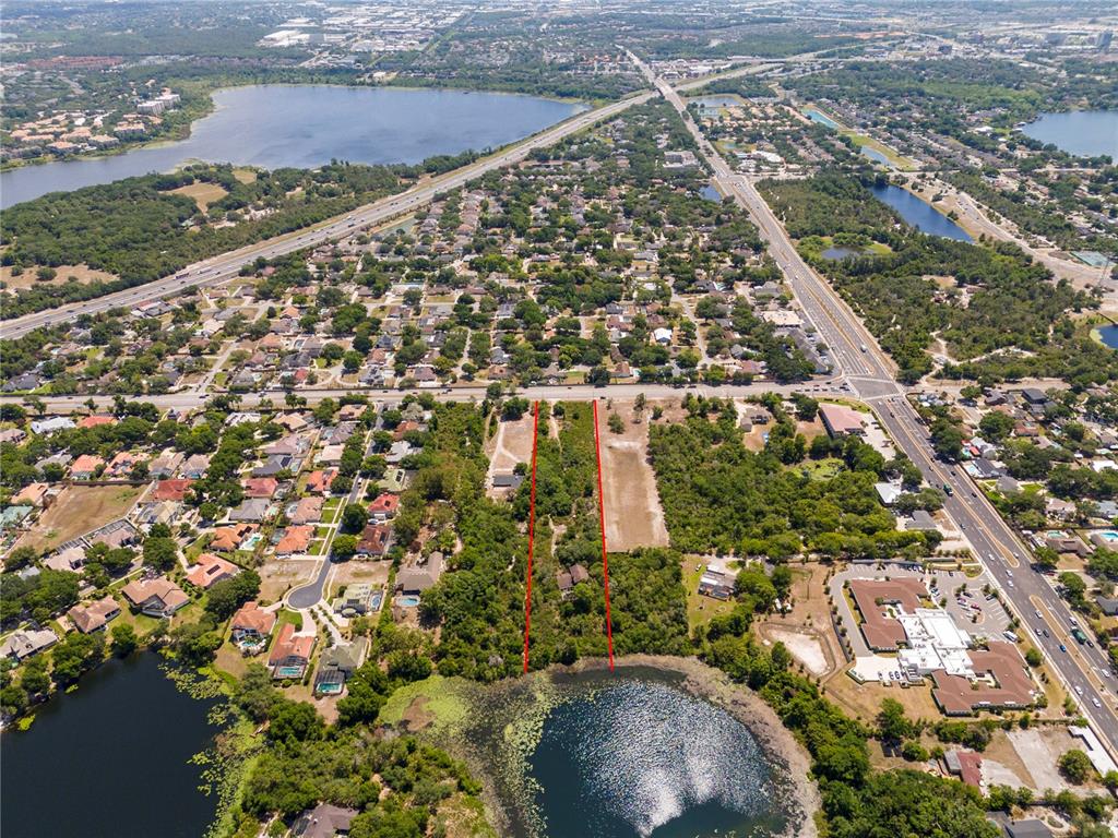 An aerial view shows a vacant, wooded lot outlined in red bordering a small lake — 4512 S HIAWASSEE ROAD, ORLANDO, FL