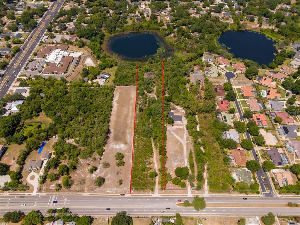 An aerial view shows a rectangular plot of land marked by red lines near lakes — 4512 S HIAWASSEE ROAD, ORLANDO, FL